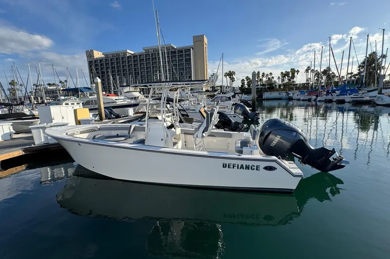 Slide: The Image of 2025 Defiance Catalina 240 boat docked in marina, clear sky, calm water. - 7