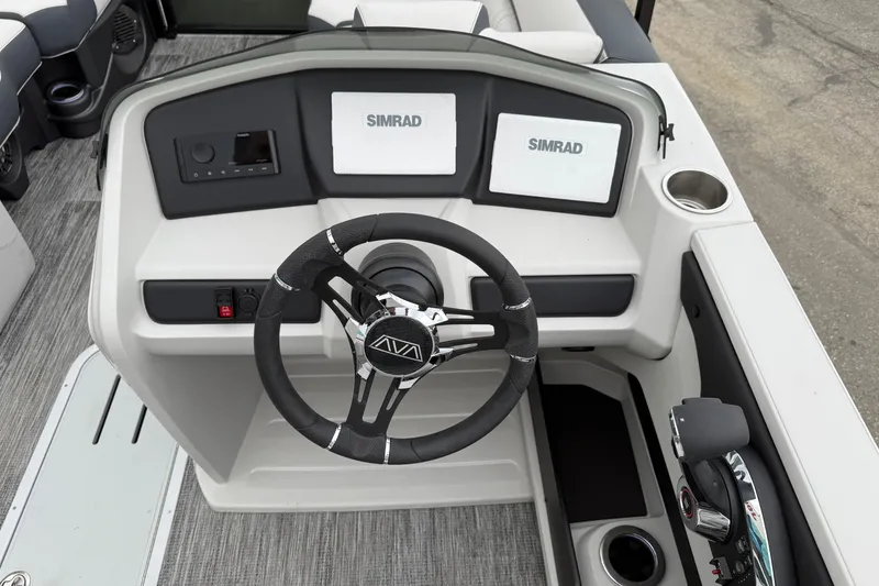 Slide: The Image of 2026 Avalon 2385 LSZ QLS boat dashboard with steering wheel and Simrad displays. - 5