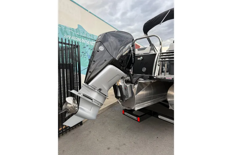 Slide: The Image of Avalon 2385 LSZ QLS 2026 boat with Mercury outboard motor, docked outdoors. - 7