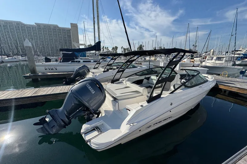 Slide: The Image of 2024 Regal 21 OBX boat docked in marina with Yamaha outboard motor. - 4