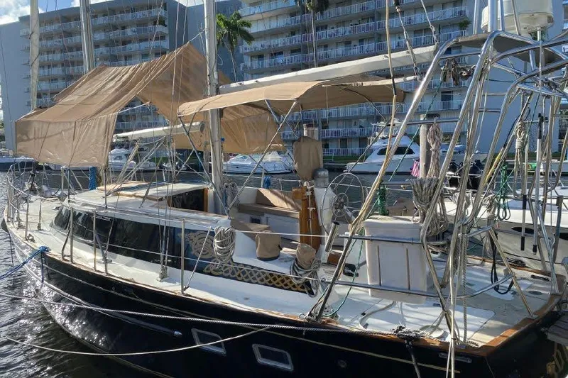 The Image of 1977 Dufour CT 12000 sailboat docked, featuring beige canopy and sleek design. - 0