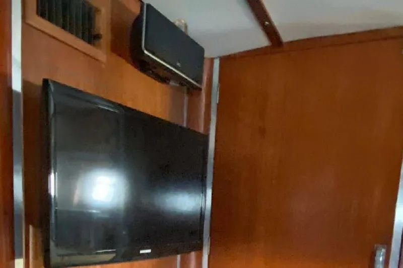 Slide: The Image of Interior of 1977 Dufour CT 12000 yacht with mounted TV and speaker. - 14