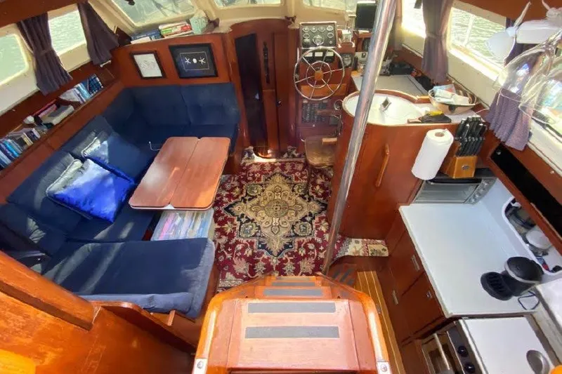 Slide: The Image of Interior of 1977 Dufour CT 12000 yacht with cozy seating and nautical decor. - 20