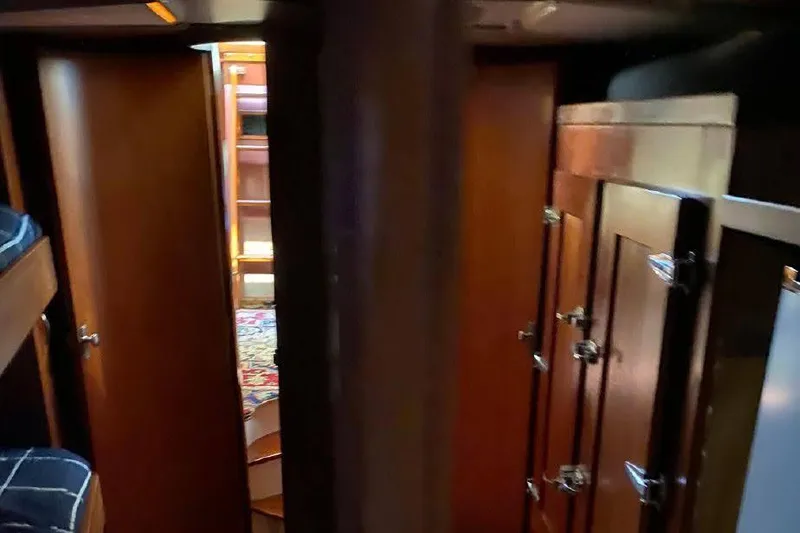 Slide: The Image of Interior of 1977 Dufour CT 12000 yacht with wooden cabinetry and cozy design. - 22