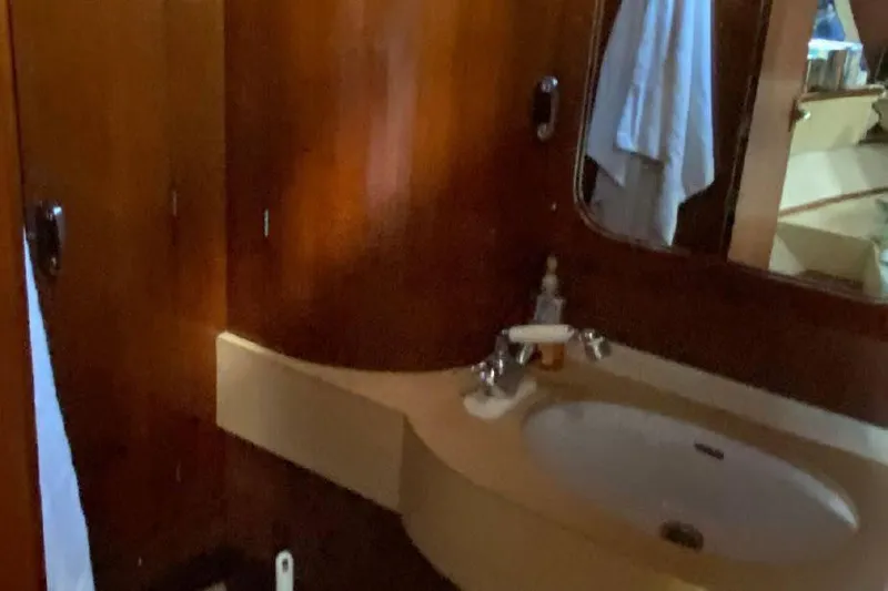 Slide: The Image of Bathroom interior of 1977 Dufour CT 12000 yacht with wooden finish and sink. - 23