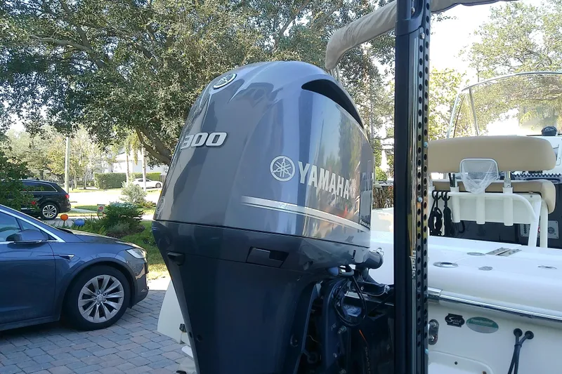Slide: The Image of 2018 Scout 251 XSS boat with Yamaha 300 outboard motor in driveway. - 10