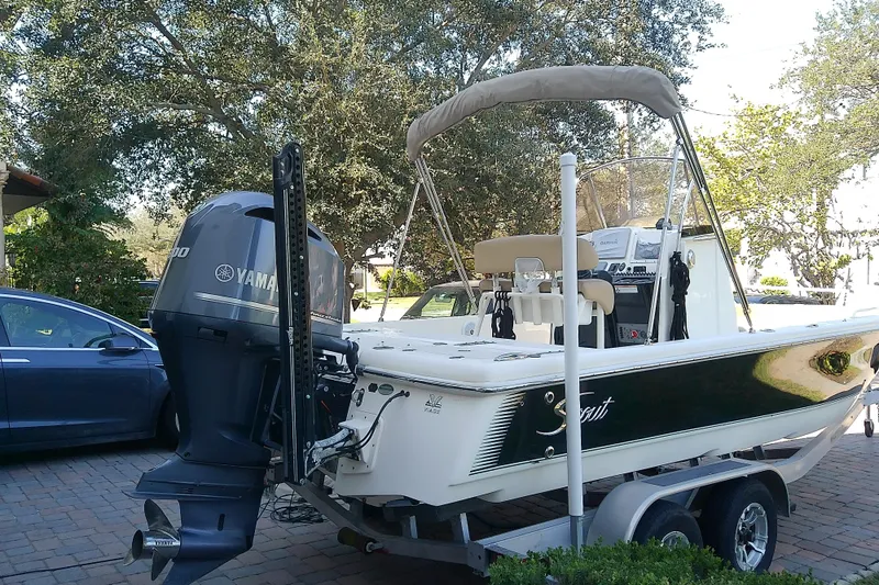 Slide: The Image of 2018 Scout 251 XSS boat with Yamaha engine on trailer in driveway. - 11