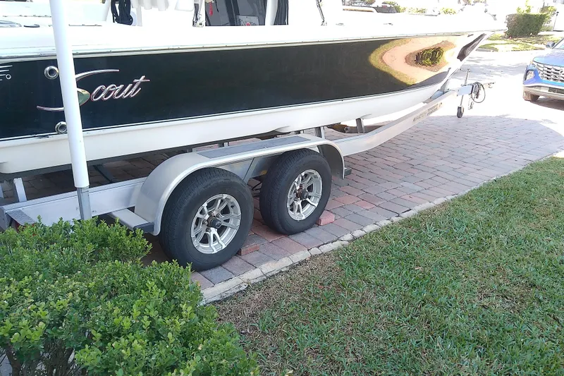Slide: The Image of 2018 Scout 251 XSS boat on trailer, parked on brick driveway. - 12