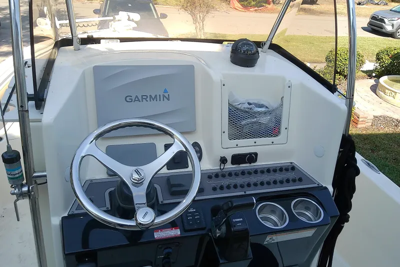 Slide: The Image of 2018 Scout 251 XSS boat dashboard with Garmin navigation system and steering wheel. - 13