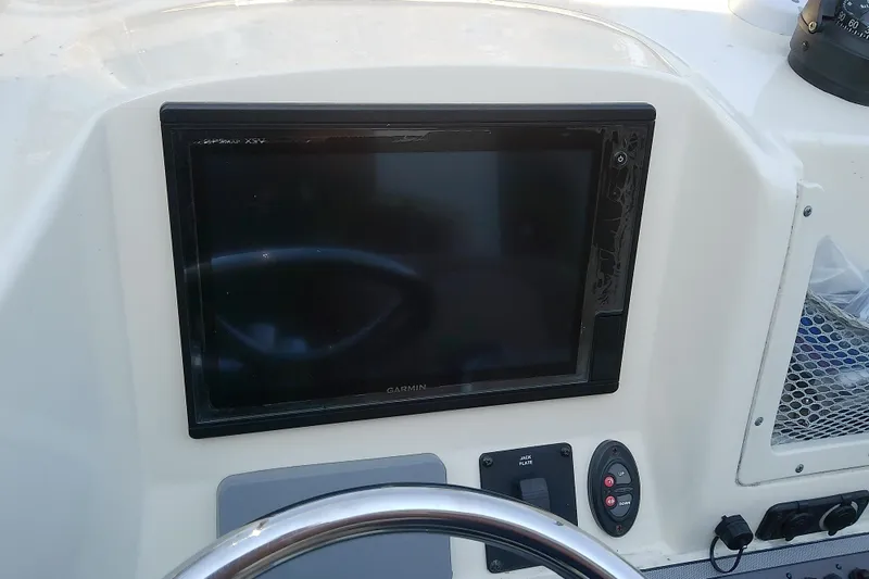 Slide: The Image of 2018 Scout 251 XSS boat dashboard with Garmin display and controls. - 14