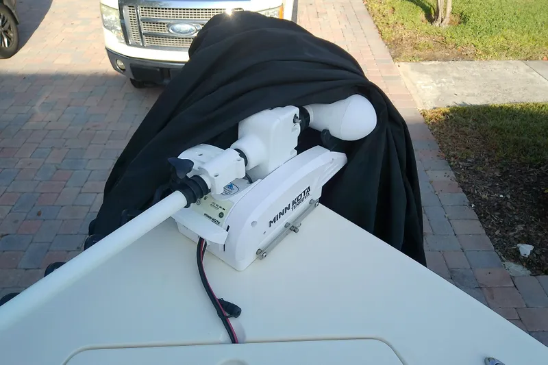Slide: The Image of 2018 Scout 251 XSS boat with Minn Kota trolling motor on a driveway. - 27