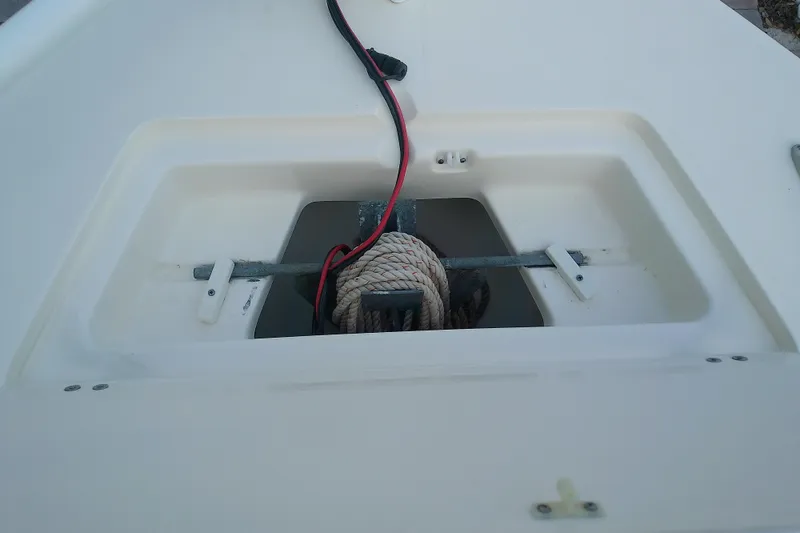 Slide: The Image of Anchor storage compartment on a 2018 Scout 251 XSS boat with coiled rope. - 28