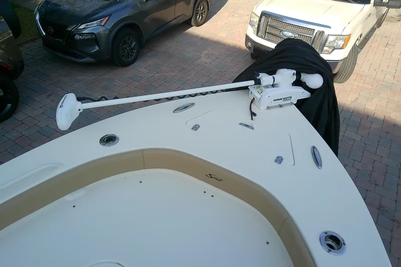 Slide: The Image of 2018 Scout 251 XSS boat with Minn Kota trolling motor on a paved driveway. - 29