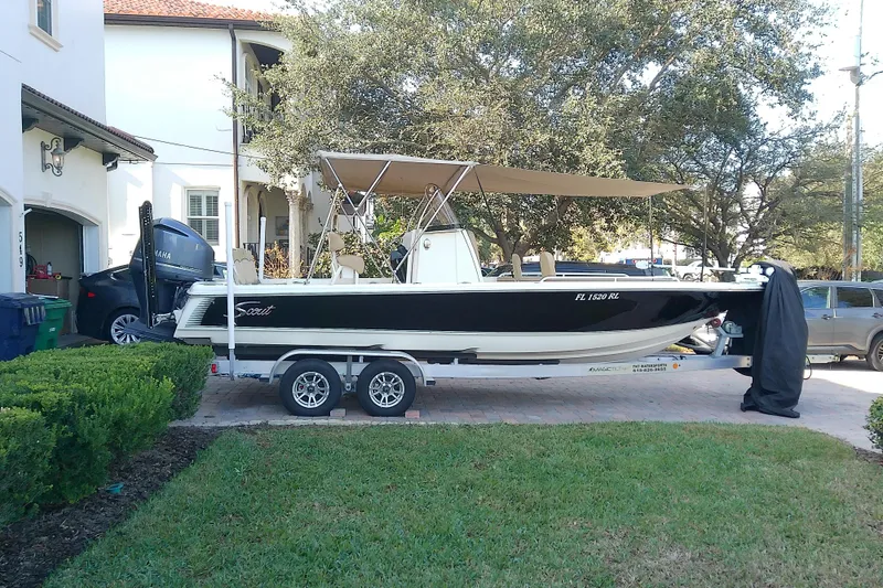 Slide: The Image of 2018 Scout 251 XSS boat on trailer, parked in residential driveway. - 3