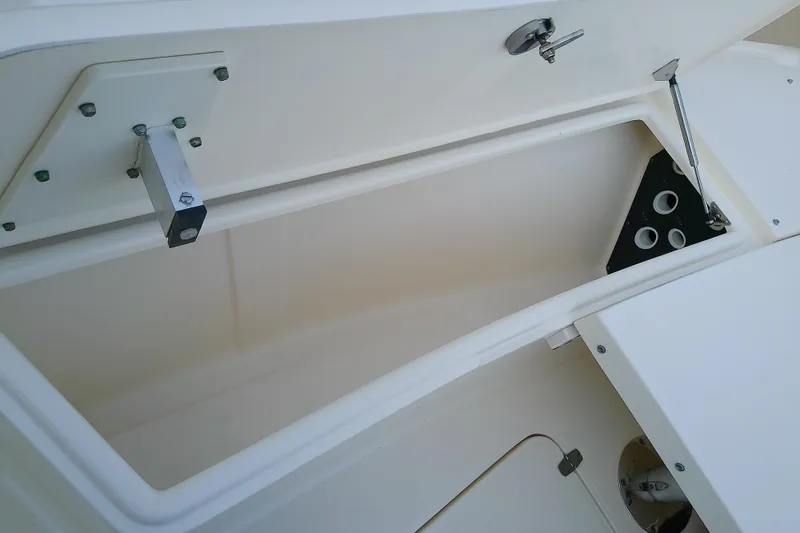 Slide: The Image of Open storage compartment on a 2018 Scout 251 XSS boat, showcasing interior details. - 32