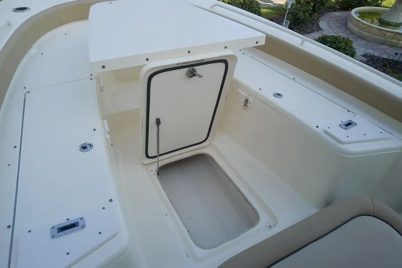 Slide: The Image of 2018 Scout 251 XSS boat interior with storage compartment open. - 34