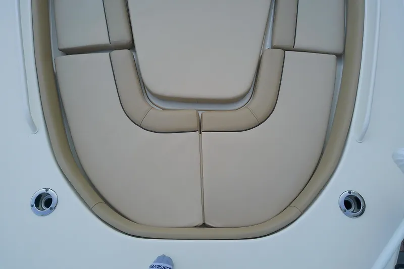 Slide: The Image of 2018 Scout 251 XSS boat with beige cushioned seating area. - 36