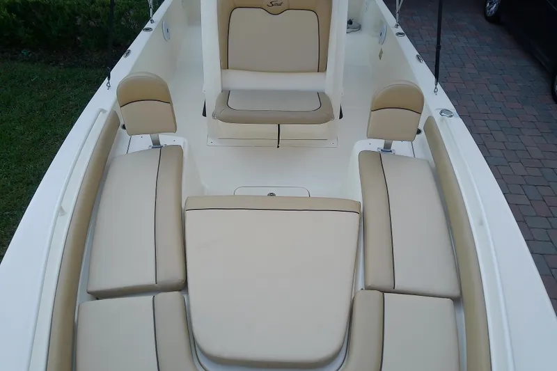 Slide: The Image of 2018 Scout 251 XSS boat interior with beige cushioned seating. - 37
