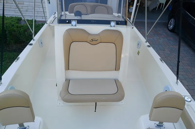 Slide: The Image of 2018 Scout 251 XSS boat interior with beige seating and console. - 38