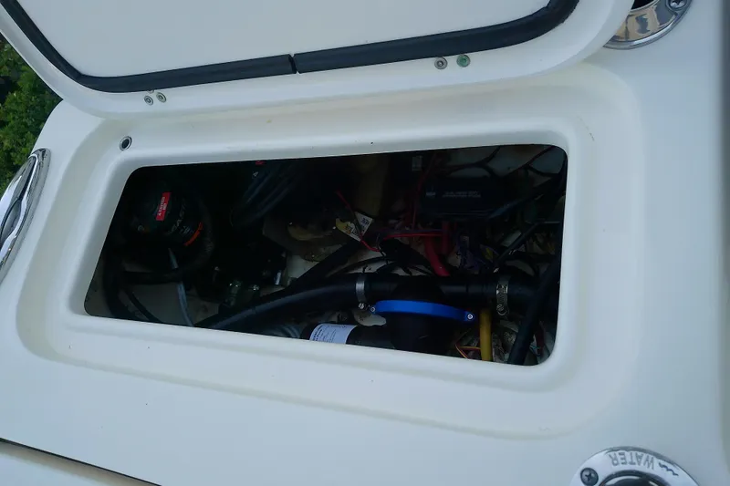 Slide: The Image of Open hatch of 2018 Scout 251 XSS boat showing internal wiring and components. - 43