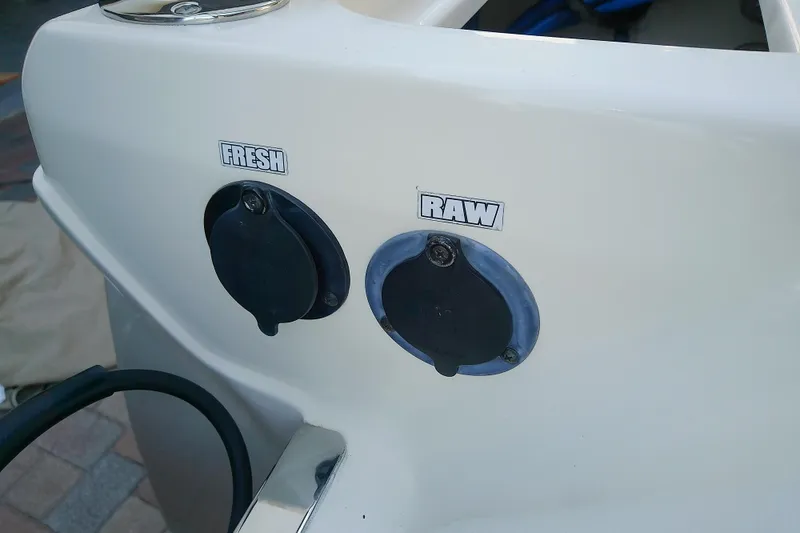 Slide: The Image of 2018 Scout 251 XSS boat with fresh and raw water outlets. - 45