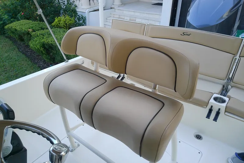 Slide: The Image of 2018 Scout 251 XSS boat with beige cushioned seating and steering wheel. - 46