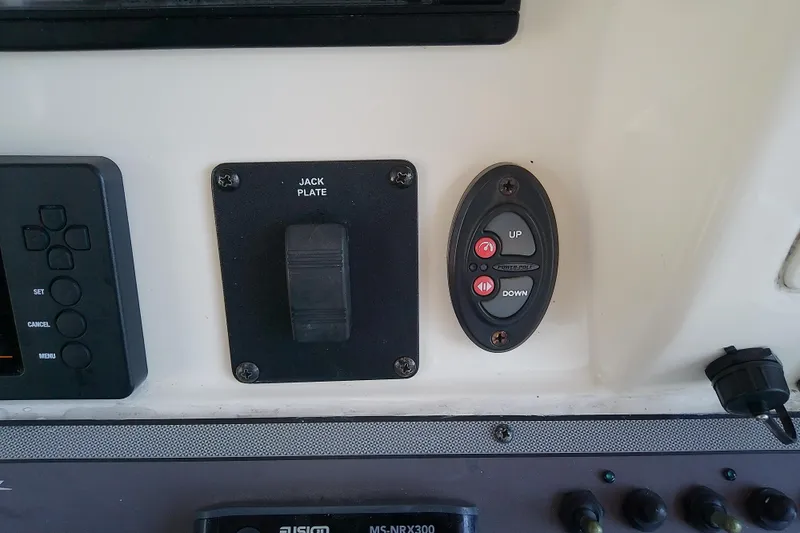 Slide: The Image of Control panel of a 2018 Scout 251 XSS boat with jack plate and power pole buttons. - 52