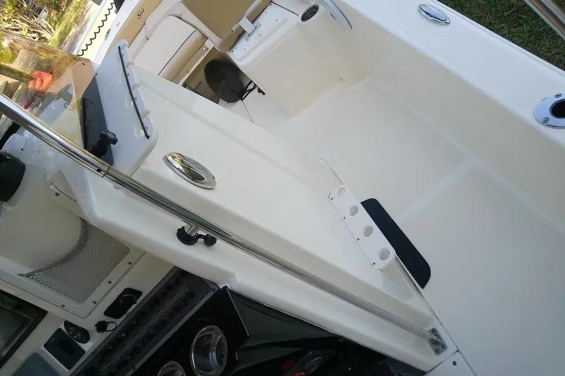 Slide: The Image of 2018 Scout 251 XSS boat interior with seating and control panel. - 55