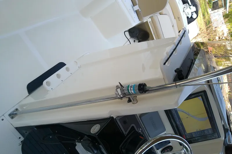 Slide: The Image of 2018 Scout 251 XSS boat interior with steering wheel and navigation equipment. - 56