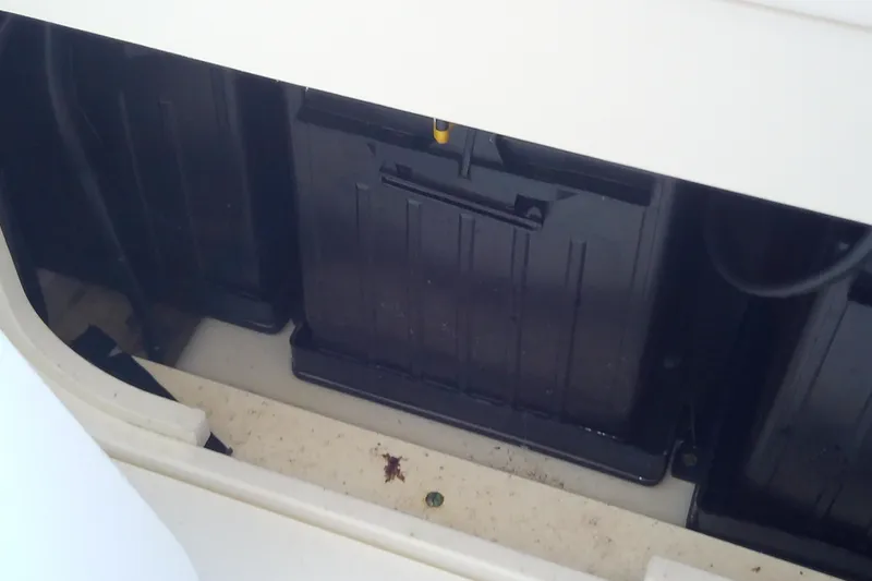 Slide: The Image of Battery compartment of a 2018 Scout 251 XSS boat, showing black battery cases. - 60
