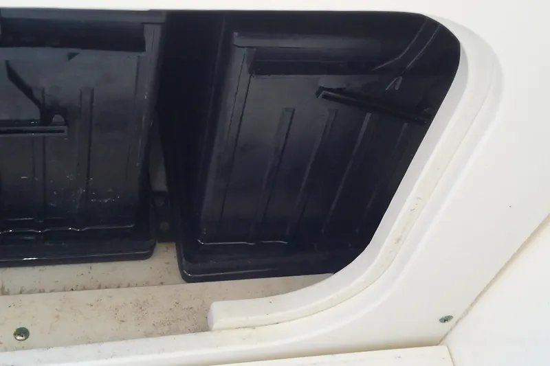 Slide: The Image of 2018 Scout 251 XSS boat storage compartment with black interior. - 66