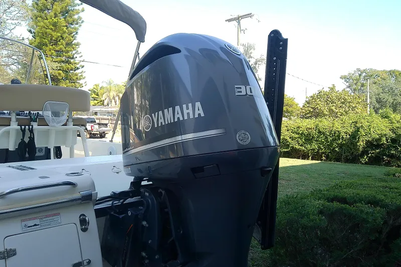 Slide: The Image of 2018 Scout 251 XSS boat with Yamaha 300 outboard motor in a sunny yard. - 7
