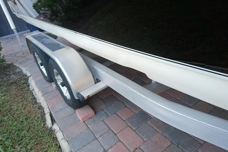 Slide: The Image of 2018 Scout 251 XSS boat trailer on brick driveway. - 71
