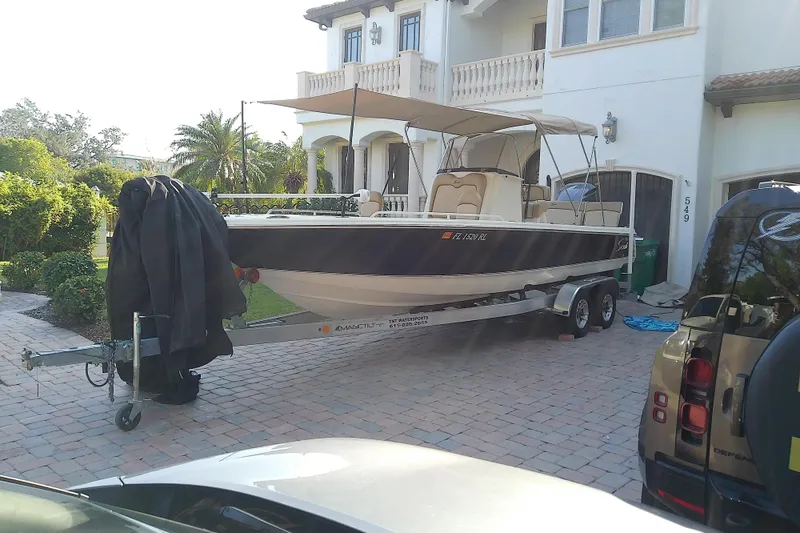 Slide: The Image of 2018 Scout 251 XSS boat on trailer in residential driveway. - 75