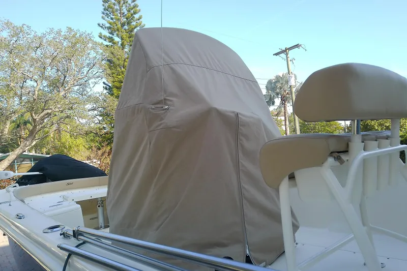 Slide: The Image of 2018 Scout 251 XSS boat with covered console and seating, outdoors. - 76