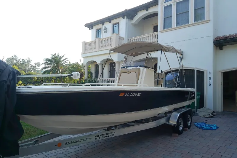 Slide: The Image of 2018 Scout 251 XSS boat on trailer in front of a house. - 78