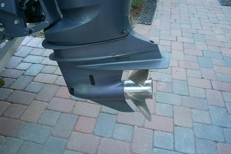 Slide: The Image of 2018 Scout 251 XSS boat motor and propeller on brick pavement. - 9