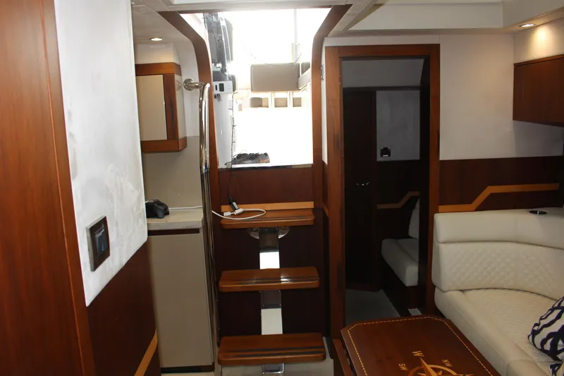 Slide: The Image of Interior of 2017 Galeon 385 HTS yacht, featuring elegant wood finishes and modern design. - 12