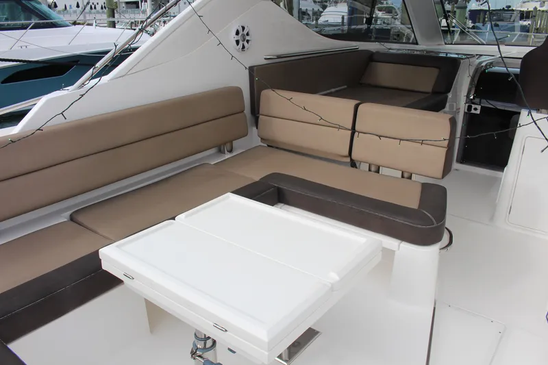 Slide: The Image of 2017 Galeon 385 HTS yacht interior with beige seating and white table. - 2
