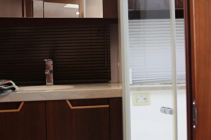 Slide: The Image of Interior of 2017 Galeon 385 HTS yacht bathroom with modern sink and wooden cabinetry. - 21