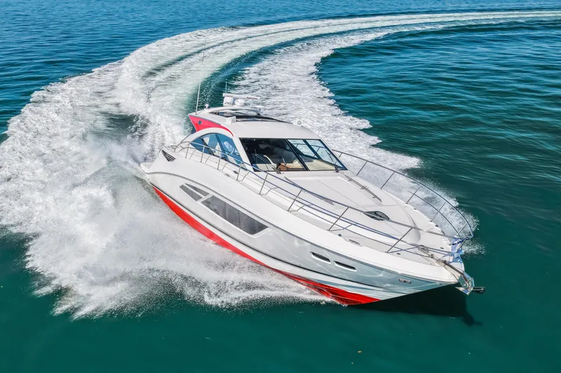 Slide: The Image of 2016 Sea Ray 510 Sundancer yacht cruising on open water, creating a dynamic wake. - 19