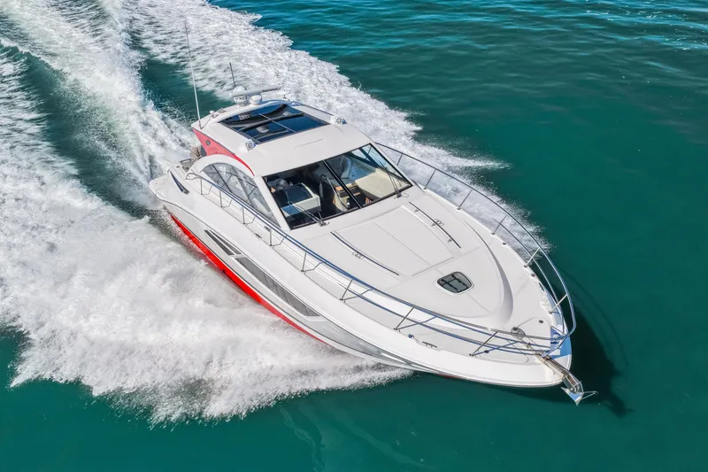 Slide: The Image of 2016 Sea Ray 510 Sundancer cruising on clear blue water. - 21