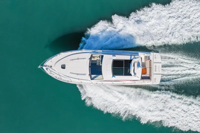 Slide: The Image of Aerial view of 2016 Sea Ray 510 Sundancer yacht cruising on turquoise water. - 22