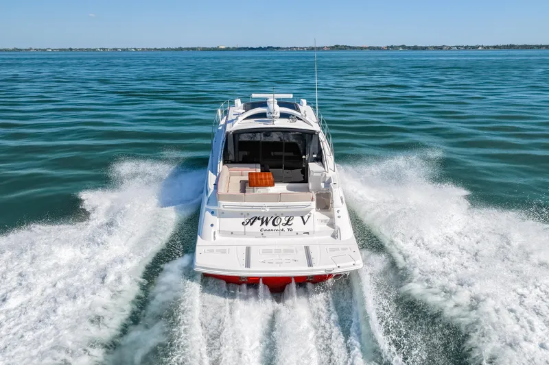 Slide: The Image of 2016 Sea Ray 510 Sundancer cruising on open water, rear view. - 26