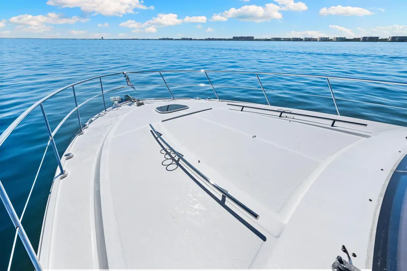Slide: The Image of 2016 Sea Ray 510 Sundancer yacht on calm blue waters under a clear sky. - 31