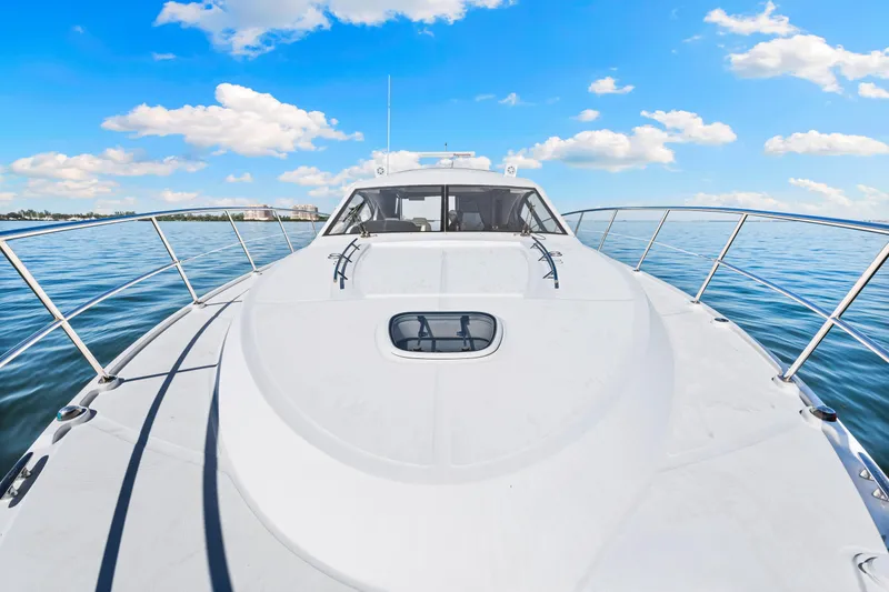 Slide: The Image of 2016 Sea Ray 510 Sundancer yacht cruising on calm blue waters under a clear sky. - 32