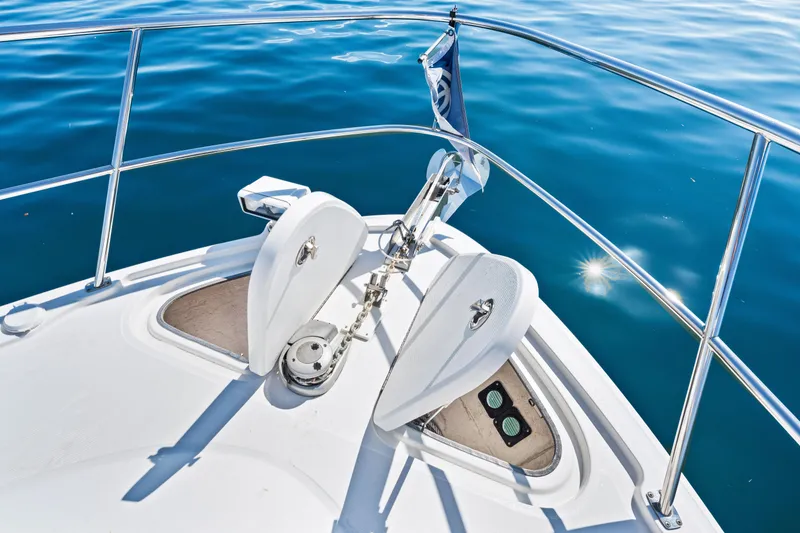 Slide: The Image of Bow of 2016 Sea Ray 510 Sundancer yacht on calm blue water. - 44