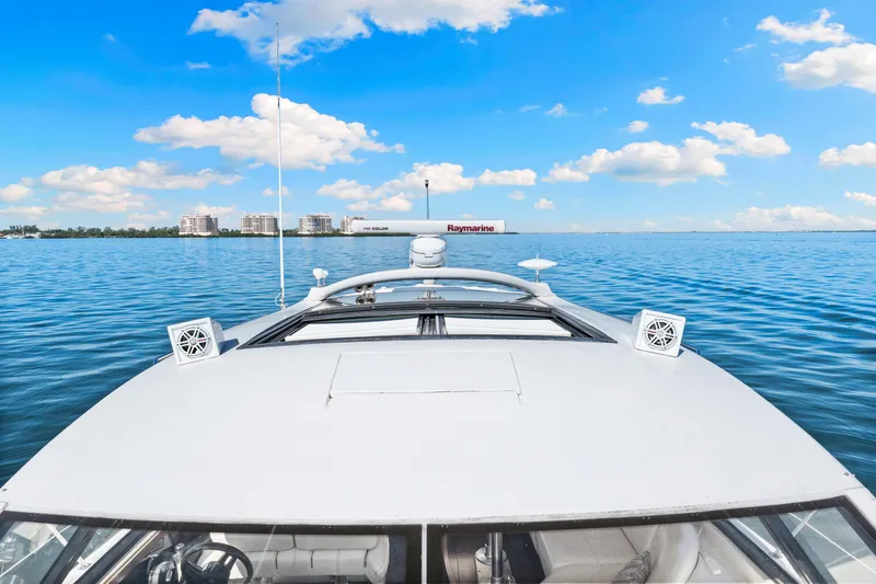 Slide: The Image of 2016 Sea Ray 510 Sundancer yacht cruising on a clear blue ocean under a sunny sky. - 45