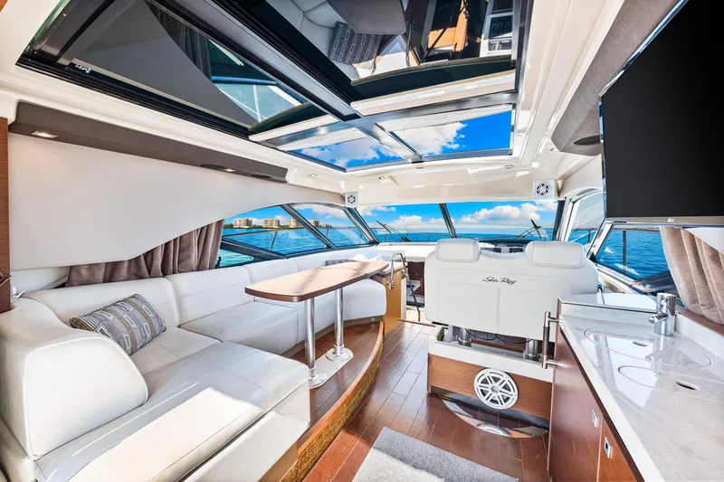 Slide: The Image of Luxurious interior of 2016 Sea Ray 510 Sundancer yacht with panoramic windows and elegant seating. - 46