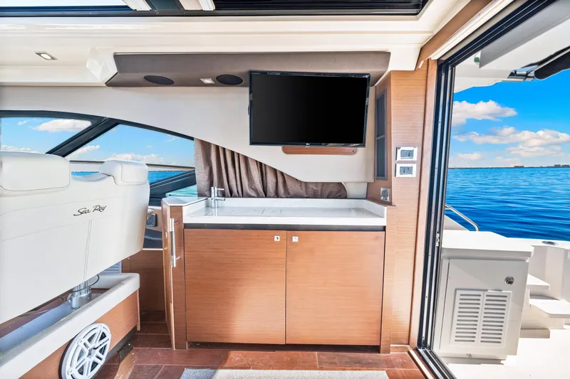 Slide: The Image of Luxurious interior of 2016 Sea Ray 510 Sundancer yacht with TV and ocean view. - 48